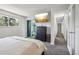 Spacious main bedroom featuring plush carpet, a mounted TV, and access to the ensuite bathroom and walk-in closet at 13030 King Cir, Broomfield, CO 80020
