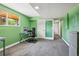 Bright home office with green walls, a work station, and a view to the outside at 13030 King Cir, Broomfield, CO 80020