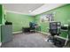 Home office with bright green walls, carpeted floor, and dual workstations at 13030 King Cir, Broomfield, CO 80020