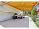 Covered patio with stone pavers, comfortable seating, and lush landscaping at 13030 King Cir, Broomfield, CO 80020