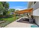 Outdoor patio with overhead covering, comfortable seating, and view of backyard and lawn at 13030 King Cir, Broomfield, CO 80020