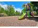 Charming community playground in a park-like setting with slides on a sunny day at 13030 King Cir, Broomfield, CO 80020