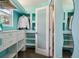 Stylish walk-in closet with custom shelving, bright turquoise accent walls, and natural light at 13030 King Cir, Broomfield, CO 80020