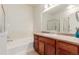 Well-lit bathroom featuring a bathtub, modern fixtures, and a vanity with ample counter space at 13456 Via Varra # 224, Broomfield, CO 80020
