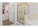 Well-lit bathroom featuring a bathtub, shower stall and neutral-toned tile at 13456 Via Varra # 224, Broomfield, CO 80020