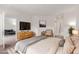 Bright bedroom featuring a large bed, modern furniture, and a glimpse into an adjacent living area at 13456 Via Varra # 224, Broomfield, CO 80020