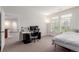 Well-lit room with a bed, a desk, and an adjacent room, providing a comfortable and functional space at 13456 Via Varra # 224, Broomfield, CO 80020