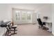 Bright bedroom featuring three windows, a desk, and an adjacent living area, perfect for work or relaxation at 13456 Via Varra # 224, Broomfield, CO 80020