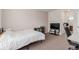 Cozy bedroom featuring a bed, a desk area, a television, and plush carpeting at 13456 Via Varra # 224, Broomfield, CO 80020