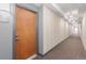 Well-lit hallway leading to unit 224, showcasing clean walls and modern carpet at 13456 Via Varra # 224, Broomfield, CO 80020