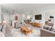 Bright living room featuring modern furniture, a cozy rug, and seamless flow to the kitchen and dining areas at 13456 Via Varra # 224, Broomfield, CO 80020