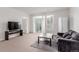 Comfortable living room with a sliding door, a modern television, and a cozy couch on a rug at 13456 Via Varra # 224, Broomfield, CO 80020