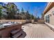 Backyard deck featuring hot tub, seating, and wooden fence at 5078 Zion Ct, Castle Rock, CO 80109
