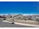 The backyard view showcasing the house and surrounding greenery under a clear blue sky at 5078 Zion Ct, Castle Rock, CO 80109