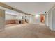 Open basement area with wet bar, wood cabinets, and staircase to the upper level at 5078 Zion Ct, Castle Rock, CO 80109