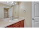 Bathroom featuring a single sink vanity with a mirror and a view of the tub/shower at 5078 Zion Ct, Castle Rock, CO 80109