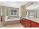 This bathroom features a soaking tub, tiled shower, and a vanity with a large mirror and modern lighting at 5078 Zion Ct, Castle Rock, CO 80109
