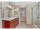 This bathroom features a tiled shower, vanity with modern lighting, and an adjacent toilet room at 5078 Zion Ct, Castle Rock, CO 80109