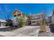 Two story home with stone accents, covered porch, driveway and landscaping with trees against a clear blue sky at 5078 Zion Ct, Castle Rock, CO 80109