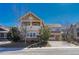 Two story home with stone accents, balcony, covered porch, driveway and landscaping against a clear blue sky at 5078 Zion Ct, Castle Rock, CO 80109