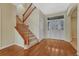 Welcoming foyer with hardwood floors, staircase with wood railing and decorative front door with sidelights at 5078 Zion Ct, Castle Rock, CO 80109