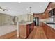 Open concept kitchen with stainless steel appliances, wood cabinets and hardwood floors at 5078 Zion Ct, Castle Rock, CO 80109