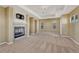 Spacious living room with cozy fireplace, neutral carpet, and ample natural light at 5078 Zion Ct, Castle Rock, CO 80109