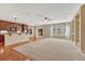 Open concept living room with carpet, hardwood floors, large windows and view of kitchen and breakfast bar at 5078 Zion Ct, Castle Rock, CO 80109