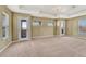 Spacious living room with neutral walls, neutral carpet, and multiple windows at 5078 Zion Ct, Castle Rock, CO 80109