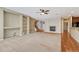 Open concept living room with built in shelving, fireplace, carpet, hardwood floors and staircase at 5078 Zion Ct, Castle Rock, CO 80109