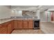 Wet bar featuring wood cabinets, granite countertop, and beverage cooler at 5078 Zion Ct, Castle Rock, CO 80109
