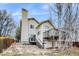 Spacious backyard with a raised deck, patio area, and mature trees, perfect for outdoor entertaining and relaxation at 3653 S Flanders St, Aurora, CO 80013