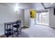 Finished basement area with neutral carpet, desk, and sliding glass doors leading to the outdoor living space at 3653 S Flanders St, Aurora, CO 80013