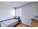 Small room featuring carpet, neutral paint, window, a bed frame and wooden side table for storage at 3653 S Flanders St, Aurora, CO 80013