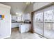 Open kitchen with an access door to the large deck, bright granite countertops and white cabinets and appliances at 3653 S Flanders St, Aurora, CO 80013