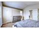 Bright bedroom features neutral walls, plush carpet, a dresser and access to bathroom and additional rooms at 3653 S Flanders St, Aurora, CO 80013