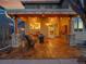 Inviting outdoor space with warm string lights, wood-look tile and comfortable seating for enjoying evening relaxation at 9845 Glenstone Trl, Highlands Ranch, CO 80130