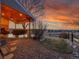 Landscaped backyard retreat featuring a covered patio, stone accents, and a serene view of the open landscape at 9845 Glenstone Trl, Highlands Ranch, CO 80130