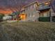 Exterior view of a beautiful two-story home with a charming covered patio and well-manicured lawn at 9845 Glenstone Trl, Highlands Ranch, CO 80130