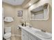 Well-lit bathroom with double sinks, a decorative mirror, and a bathtub shower combo at 9845 Glenstone Trl, Highlands Ranch, CO 80130