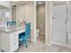 Bright bathroom with a walk-in shower, vanity, and blue chair for getting ready at 9845 Glenstone Trl, Highlands Ranch, CO 80130