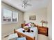 Bright bedroom featuring a large window with shutters and classic wooden nightstands at 9845 Glenstone Trl, Highlands Ranch, CO 80130