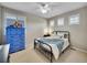 Cozy bedroom with plush carpet, a ceiling fan, a large window and a full sized bed at 9845 Glenstone Trl, Highlands Ranch, CO 80130
