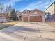 Charming two-story home featuring a three car garage and well maintained landscaping at 9845 Glenstone Trl, Highlands Ranch, CO 80130