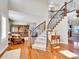 Grand foyer featuring hardwood floors, a curved staircase, and elegant iron railings at 9845 Glenstone Trl, Highlands Ranch, CO 80130