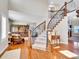 Elegant foyer with hardwood floors and a curved staircase with wrought iron railings at 9845 Glenstone Trl, Highlands Ranch, CO 80130