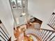 Bright foyer with tall windows, hardwood floors, and elegant staircase with iron railings at 9845 Glenstone Trl, Highlands Ranch, CO 80130