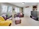 A comfortable living room with sofas, shelves, and a television, perfect for relaxation at 9845 Glenstone Trl, Highlands Ranch, CO 80130