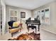 Comfortable music room with a piano and natural light from shuttered windows at 9845 Glenstone Trl, Highlands Ranch, CO 80130
