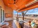 Covered patio with wood ceiling, stone pillar, and outdoor furniture, perfect for relaxing and enjoying the view at 9845 Glenstone Trl, Highlands Ranch, CO 80130